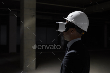 gear at construction site while visualizing future project in 3D, copy space