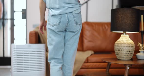 Woman with Air Purifier or Conditioner at Home