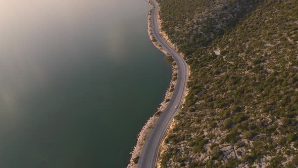 Aerial Drone View on Narrow Road with Cars Between Sea and Mountains