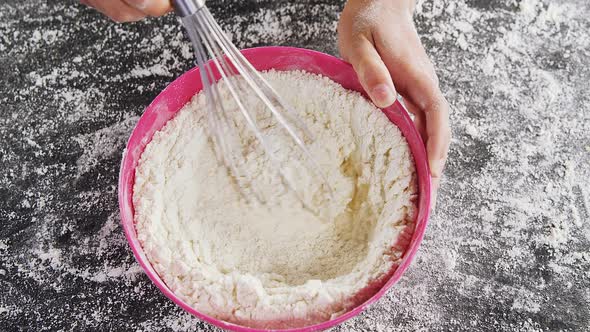 Woman whisking flour in bowl 4k