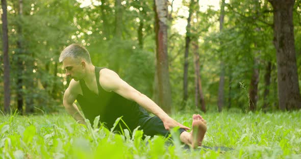 Man Doing Yoga in Nice Park