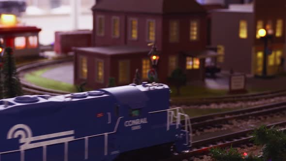 Blue Locomotive And Several Brightly Colored Box Cars