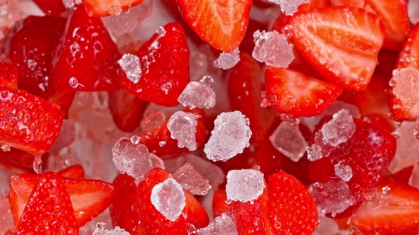 Super Slow Motion Shot of Fresh Strawberries and Crushed Ice Flying Towards Camera at 1000Fps