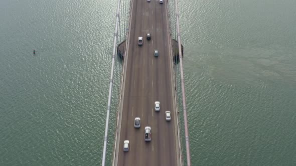 Aerial: traffic passing through the bridge, drone view