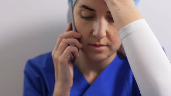 Sad Doctor or Nurse Calling on Smartphone