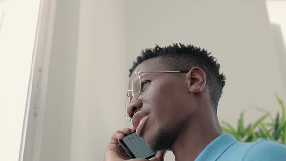 Bottom View of Young Man with Smartphone.