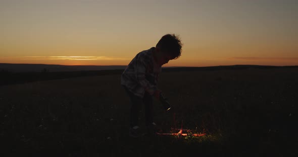 A Boy Playing with a Big Flashlight