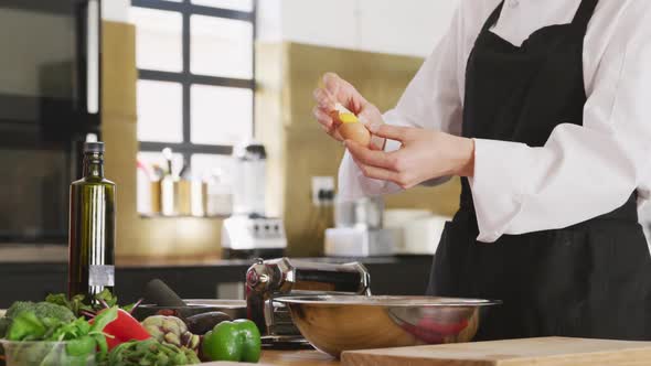 Chef breaking an egg