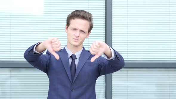 Thumbs Down by Young Businessman with Both Hands