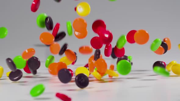 Colorful candy falls in slow motion