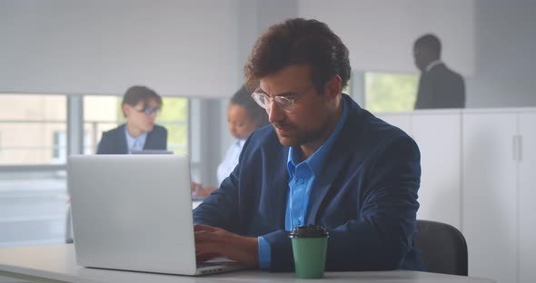 Young Employee Looking at Computer Monitor During Working Day in Office