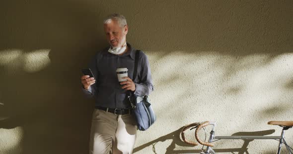 Caucasian man out and about in the street wearing on a face mask against coronavirus