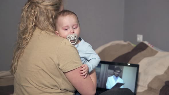 Telemedicine Concept - Young Woman Video Chat with Family Doctor Talking About Her Sick Daughter