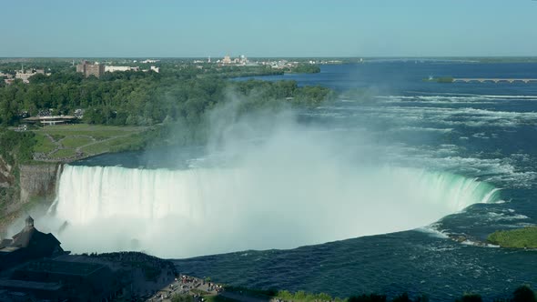 A medium shot of mist rising over Niagara Falls.