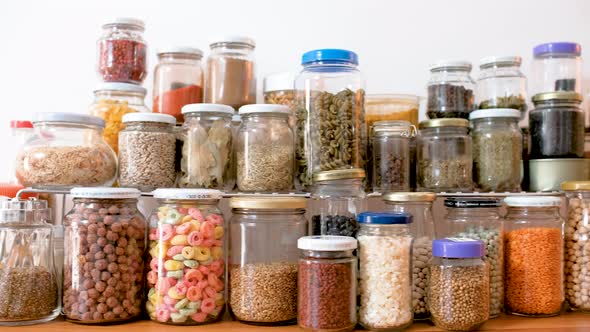 Jars of spices and cereals on kitchen counter, truck shot