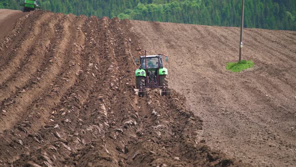 Tractor Deep Plowing a Field in Spring Natural Agriculture Cultivate Machine