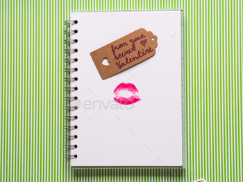 White page with girlish pen and kiss