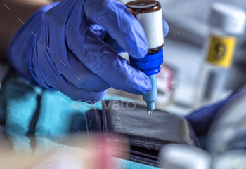 Police specialist examines wallet to collate DNA in a crime scene, conceptual image