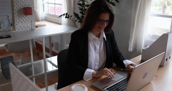 Mature woman working inside office using laptop computer - Business concept