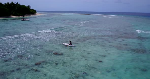 Wide angle aerial copy space shot of a sunshine white sandy paradise beach and aqua blue water backg