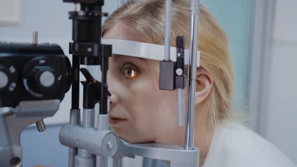 Optometrist Giving Slit Lamp Examination of the Eyes in Ophthalmology Clinic