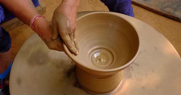 Pottery - Skilled Wet Hands of Potter Shaping the Clay on Potter Wheel. Pot, Vase Throwing