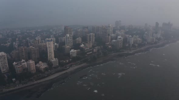 Cinematic crane drone shot of Mumbai coast BJ road Bandstand hazy