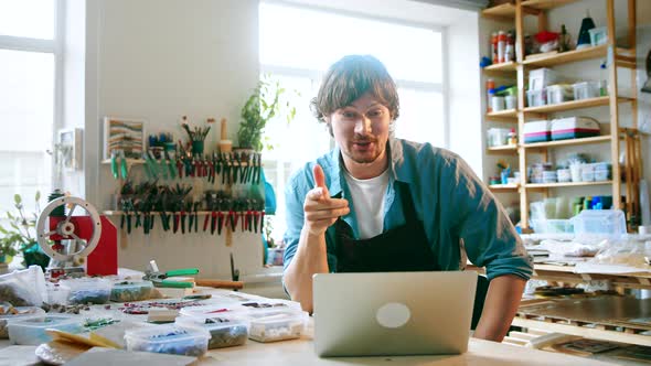 A young master conducts training online using a laptop in the studio