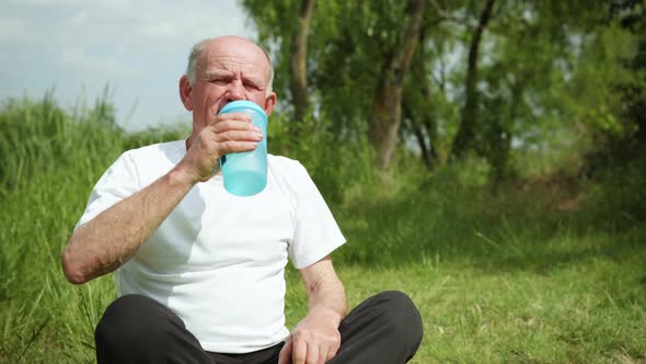 Portrait of an Elderly Healthy Man Drinking Clean Healthy Cool Water After Playing Sports and