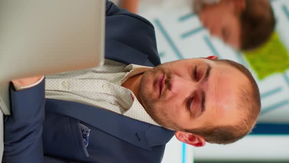 Busy Business Man Using Laptop Typing Sitting at Conference Table in Broadroom