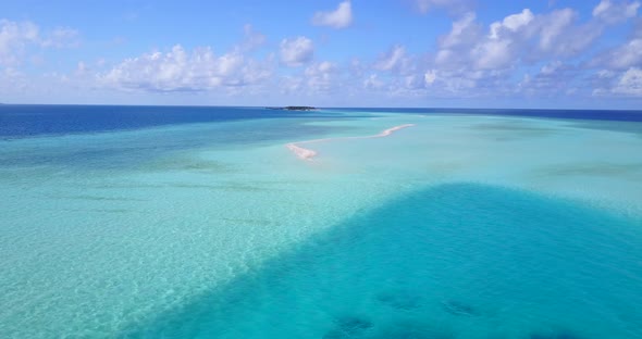 Wide angle above abstract view of a white sand paradise beach and aqua turquoise water background in