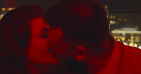 Close Up of Happy Young Couple Kissing in Restaurant Sitting Near Window