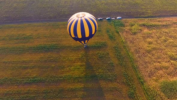 Basket of Hot Air Balloon Standing on Field, People Jumping from Gondola, Finish