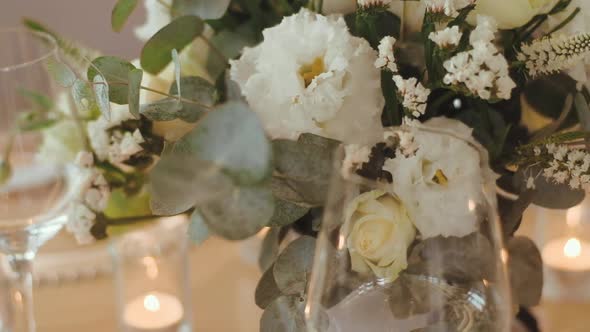 Decorated wedding table with with glasses of wine and meals at dishes