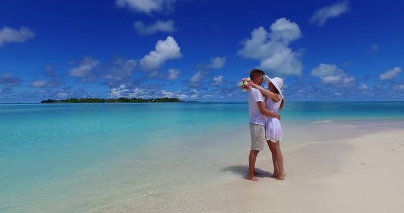 Romantic lady and man in love dating on vacation live the dream on beach on summer white sandy background