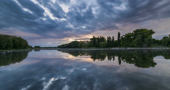 Timelapse of Beautiful Cloudy Sunrise in a Lake with Reflection