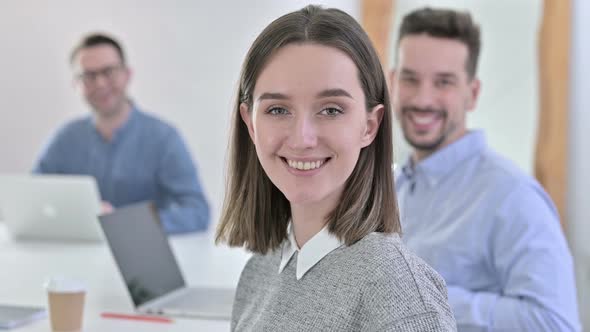 Ambitious Creative Team Smiling at the Camera in Office