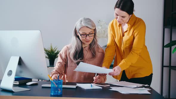 Team Two Successful Businesswoman Sitting at Desk Having Fun at Work