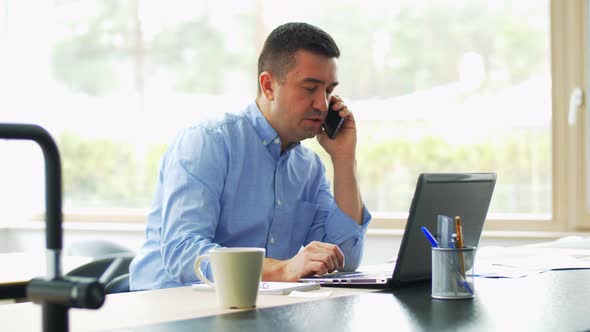 Man Calling on Smartphone at Home Office