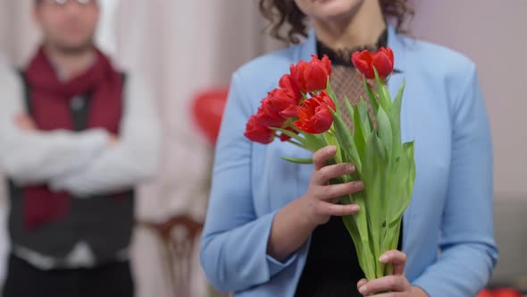 Bouquet of Flowers in Hands of Unrecognizable Caucasian Smiling Woman