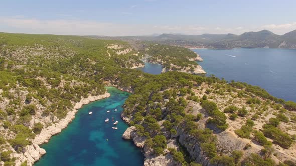 Aerial travel drone view of clear green water, cliffs of Cassis, Mediterranean Sea, Southern France.