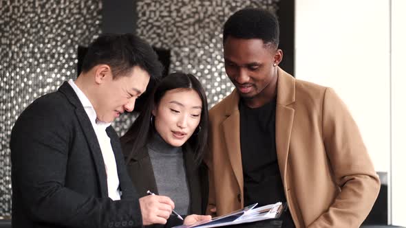 Realtor Explaining Agreement To Couple In New Apartment