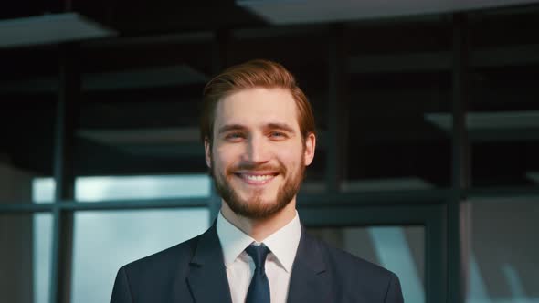 Young businessman smiling and looking at camera