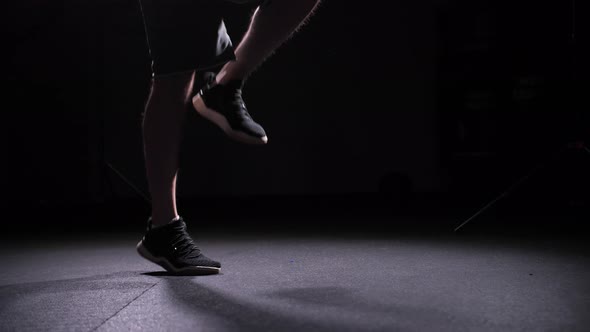 Legs of an Athlete Jumping Rope