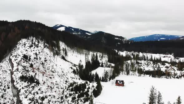 Aerial View of a Snowcovered Hill and Detached House