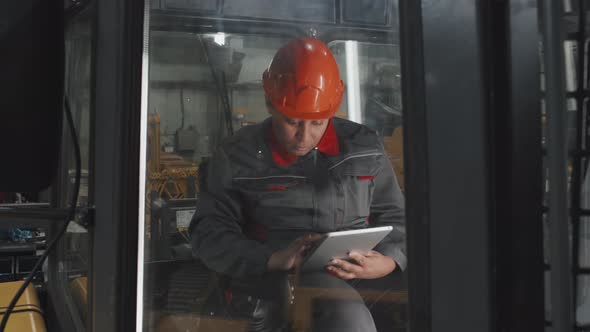 Factory Worker in Vehicle Cabin