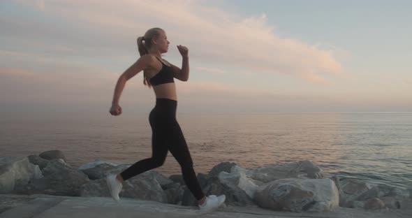 Beautiful Young Athlete Coming To Rest After Jogging At Sunset