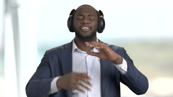 Satisfied Businessman Listening To Music in Headphones