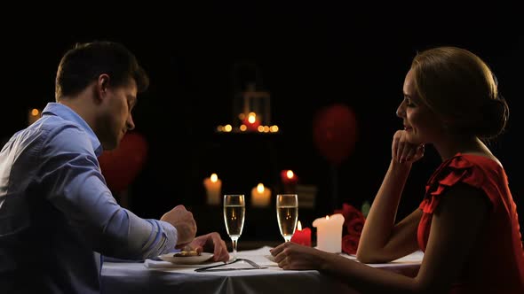 Handsome Man Feeding Pretty Lady, Couple Having Romantic Dinner at Restaurant