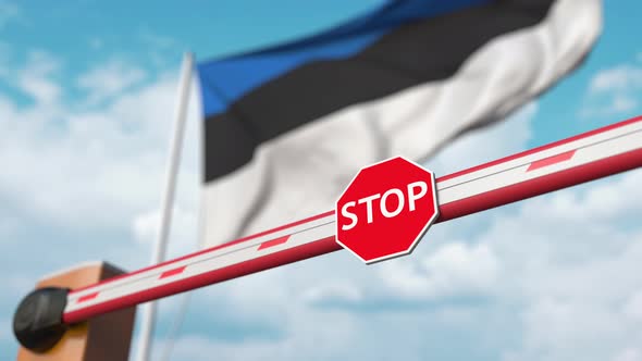 Opening Barrier with Stop Sign Against the Estonian Flag